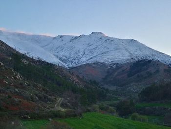 Scenic view of snowcapped mountains against clear sky