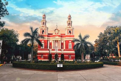 Statue in city against sky
