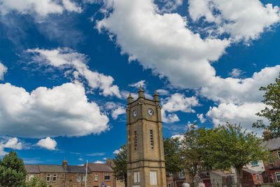 Low angle view of clock tower against sky