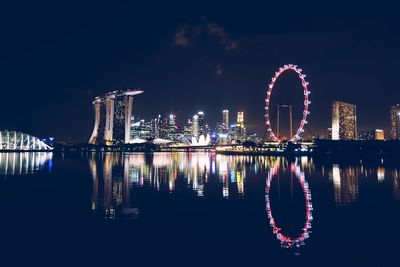 Illuminated ferris wheel at night