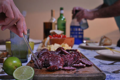 Close-up of man preparing food on cutting board