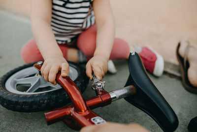 Mother and child fixing bike