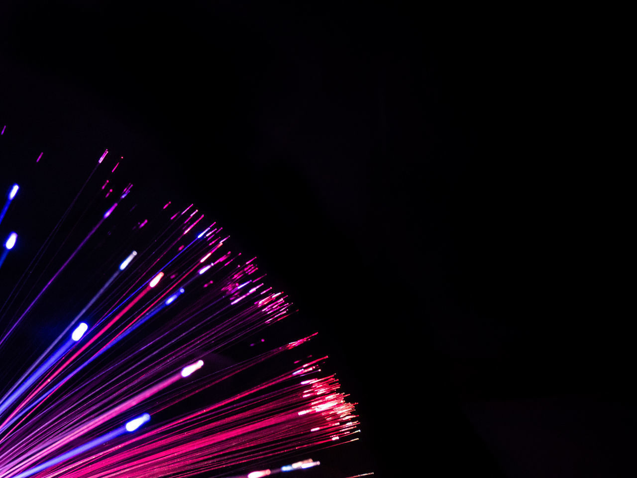 LOW ANGLE VIEW OF ILLUMINATED LIGHTING EQUIPMENT AGAINST DARK BACKGROUND