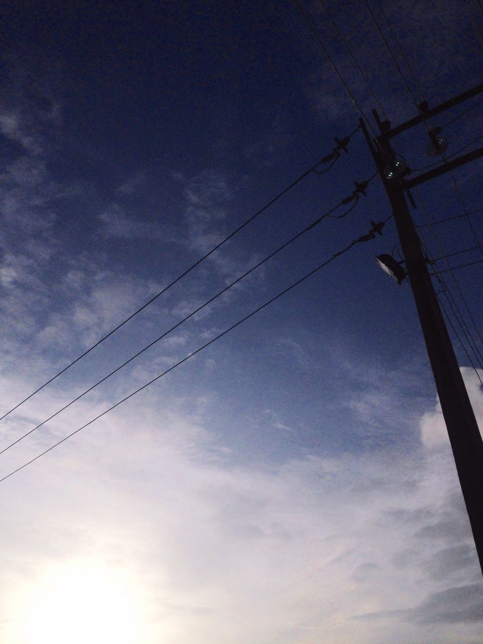 low angle view, connection, power line, electricity, sky, cable, power supply, technology, fuel and power generation, cloud - sky, cloud, electricity pylon, blue, day, tranquility, nature, outdoors, tranquil scene, tall, no people, cloudy, scenics, telephone line, beauty in nature, high section