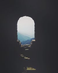 Cityscape against sky seen through arch