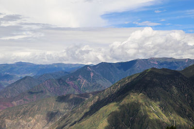 Scenic view of mountains against cloudy sky