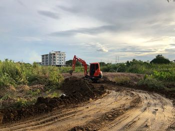 Construction site by road against sky