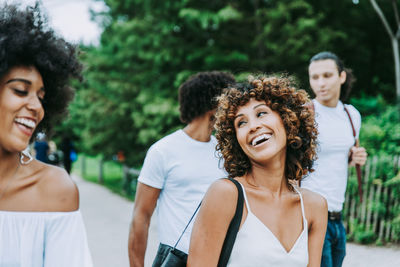 Smiling friends walking 