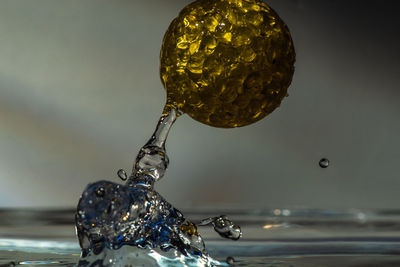 Close-up of drop falling on water