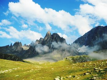 Scenic view of mountains against cloudy sky