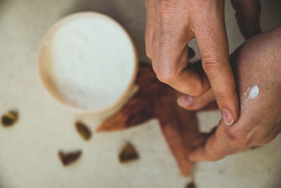 Close-up of hands applying lotion