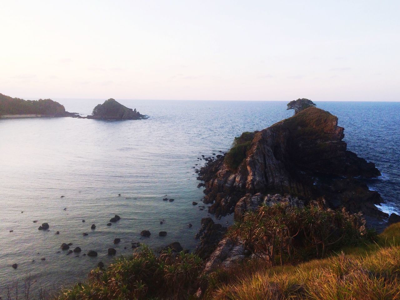 sea, horizon over water, water, tranquil scene, tranquility, scenics, beauty in nature, rock formation, rock - object, cliff, clear sky, nature, beach, rock, idyllic, shore, coastline, sky, copy space, non-urban scene