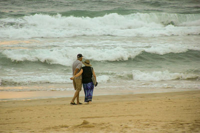 Full length of men on beach