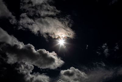 Low angle view of bright sun in sky