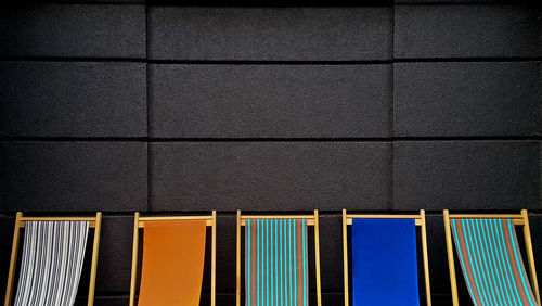 Cropped deck chairs against the wall