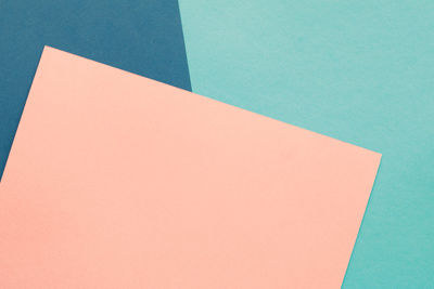 High angle view of paper on colored background