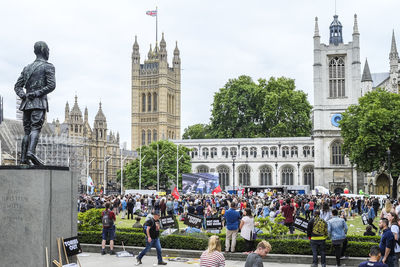 People in front of building against sky