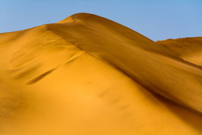 Scenic view of desert against clear sky