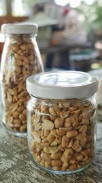 Close-up of cashews in jars on table