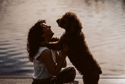 Side view of woman with dog