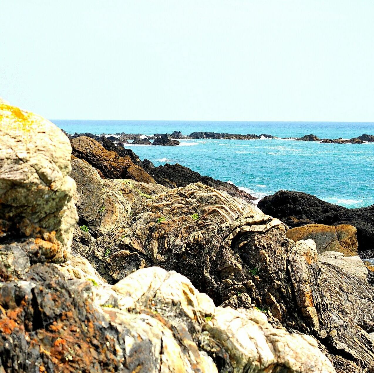 sea, horizon over water, water, clear sky, scenics, beauty in nature, rock - object, tranquil scene, tranquility, rock formation, nature, copy space, rock, beach, shore, idyllic, cliff, blue, outdoors, rocky