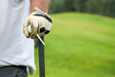 Close-up of hand holding golf course