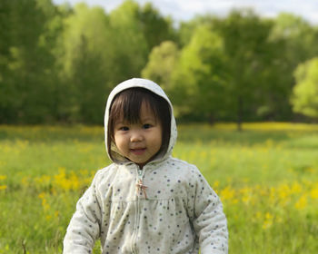 Portrait of cute girl on field