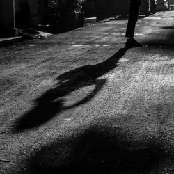 Shadow of person on street