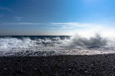 Waves crash on the black beach of djupalon on the snaefellsnes peninsula in iceland