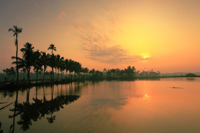 Scenic view of lake at sunset