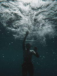 Man swimming under sea