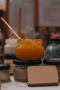 Glass jar with orange body cream or butter. spa and beauty concept. care cosmetic mockup