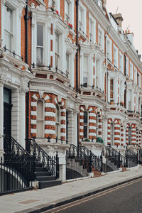 Row of traditional victorian houses with stoops in kensington and chelsea, london, uk.