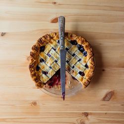 Directly above shot of knife on pie at table