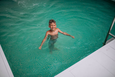 High angle view of boy swimming in pool