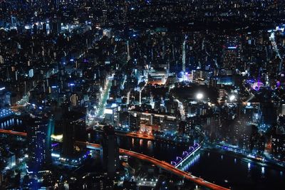 High angle view of city lit up at night