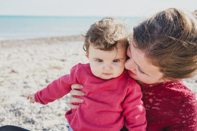 Portrait of cute baby girl on beach