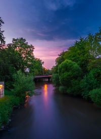 Bridge over river against sky during sunset