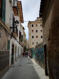 Narrow alley amidst buildings in city