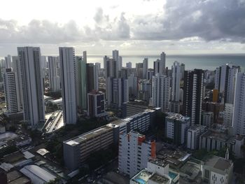 High angle view of modern buildings in city against sky