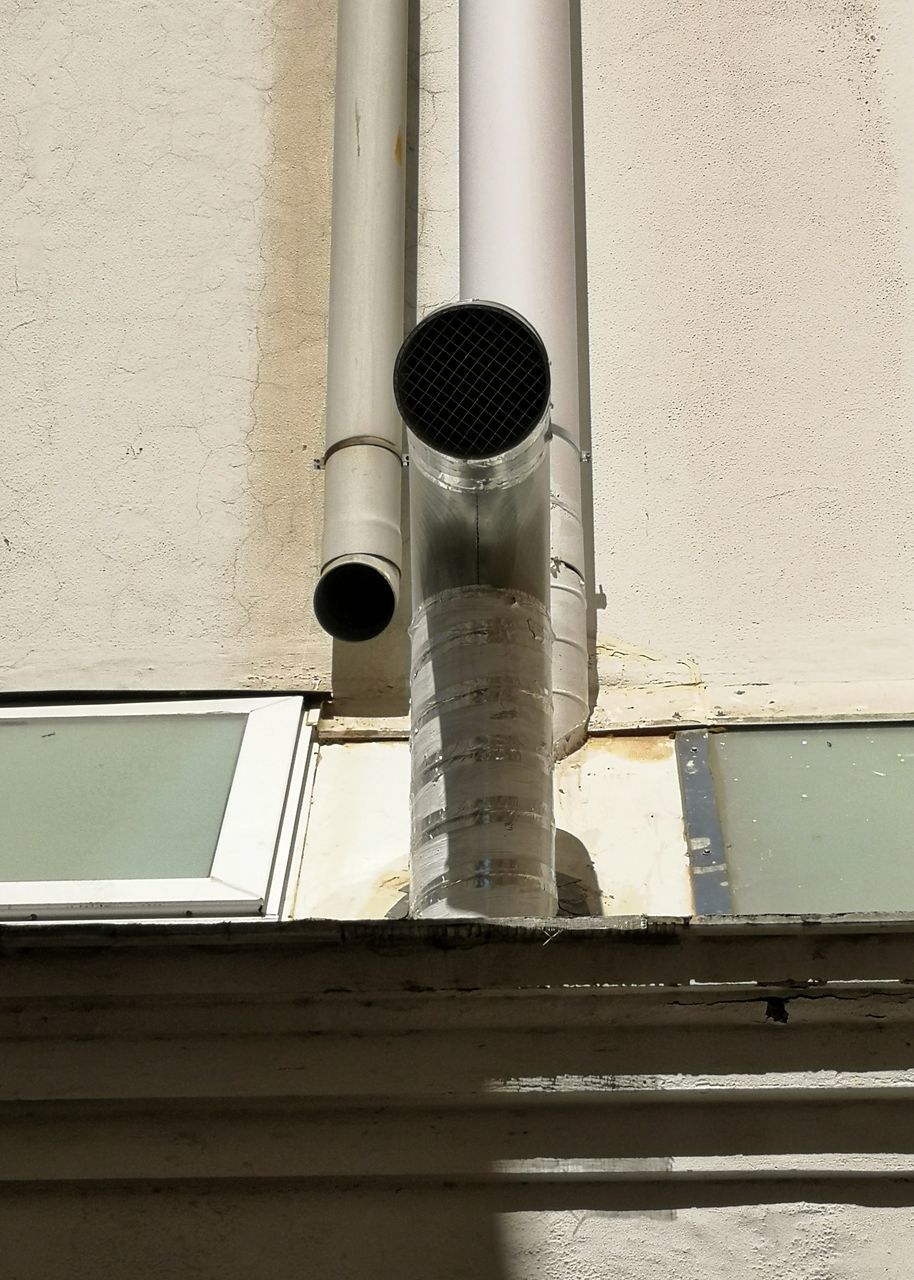 LOW ANGLE VIEW OF PIPES ON BUILDING