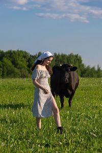 Portrait of woman standing on field