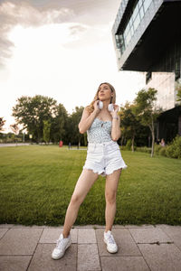 Full length of young woman standing on field