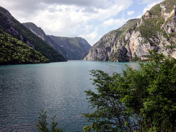 Scenic view of lake and mountains against sky