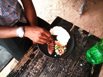 Midsection of man having food at restaurant