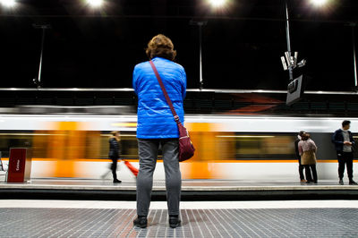 Rear view of people at railroad station