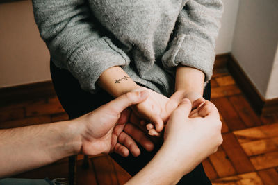 Cropped hands of woman holding baby