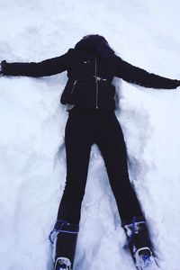 Low section of woman standing on snow