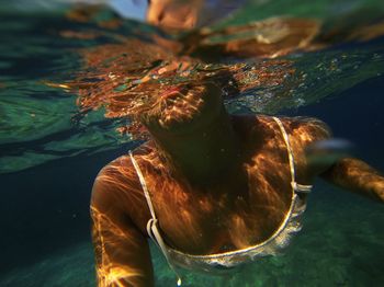 Close-up of woman swimming undersea