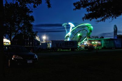 Illuminated ferris wheel at night